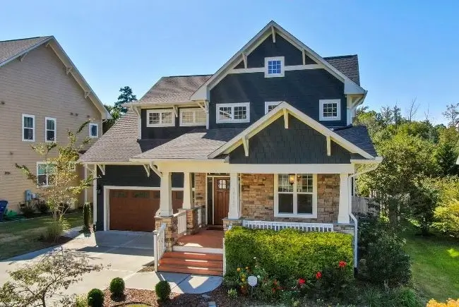 house with dark wall paint and light roof color.