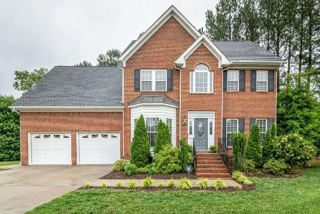 two story house with asphalt shingles.