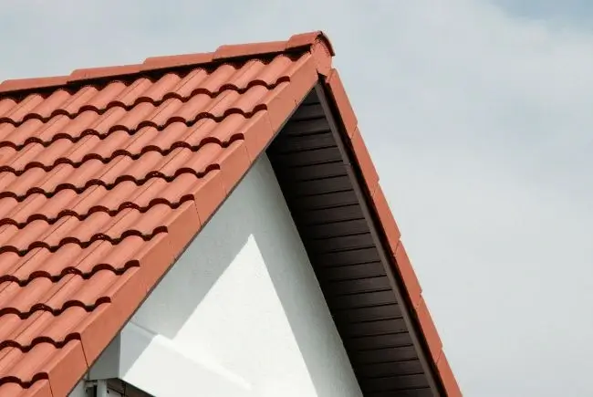 clay tile roofing against cloudy sky