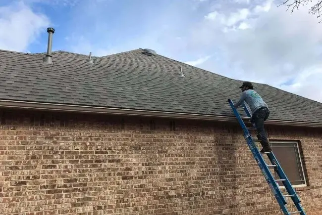 roofer climbing a roof to check roof vents